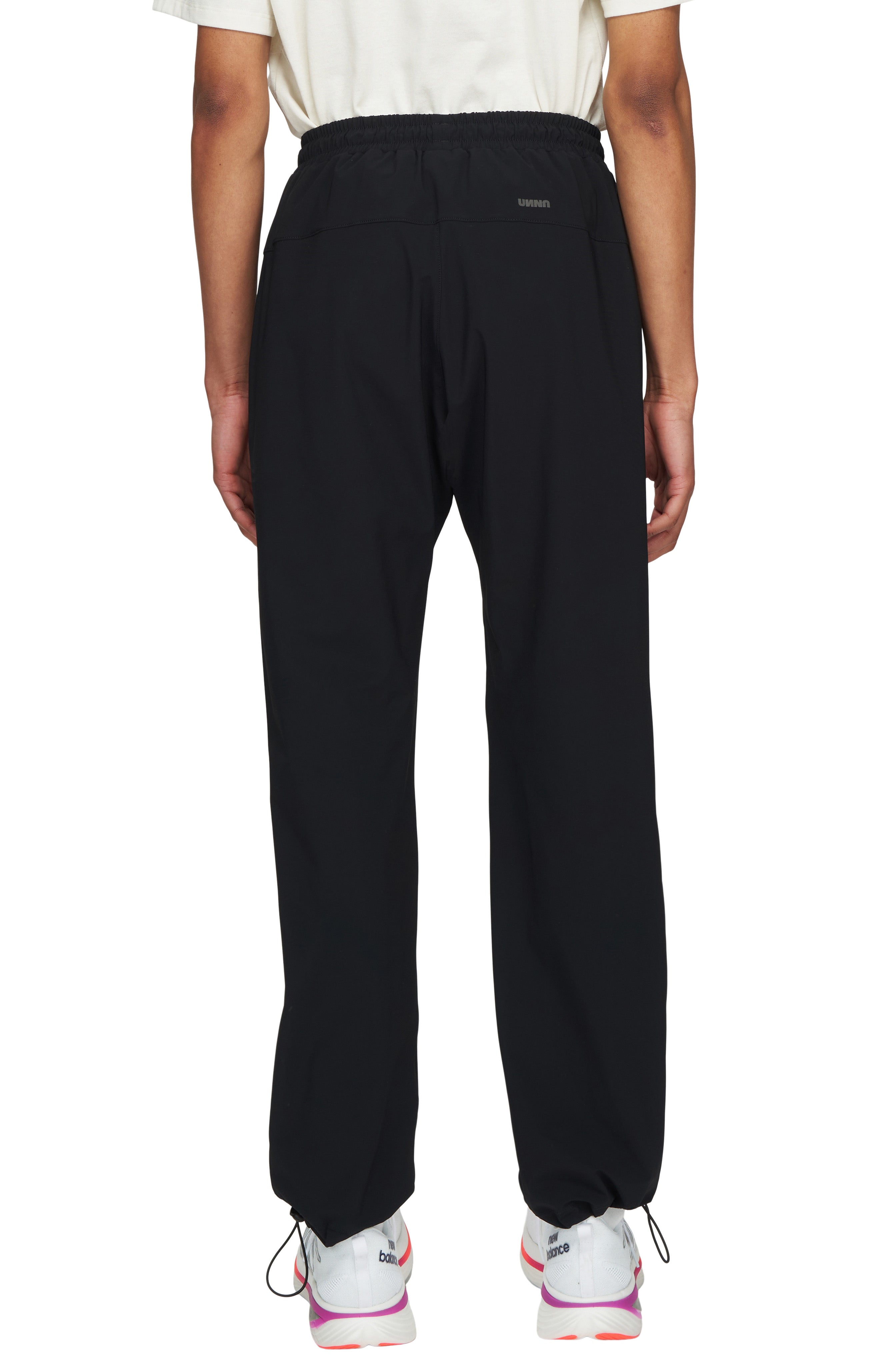 UNNA straight black running pants for men with a soft stretch and two front pockets.