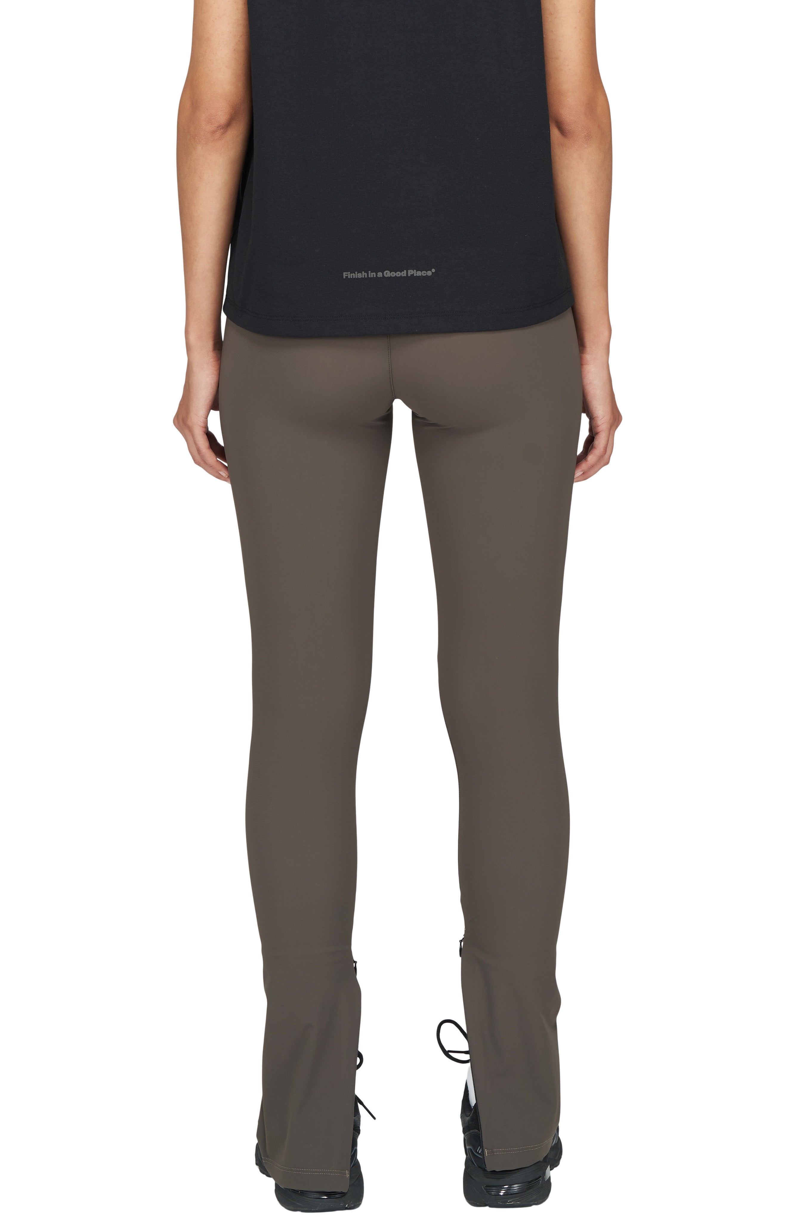 Wren green UNNA tights made in Econyl with zippered ankle slits and smart pockets.  Edit alt text
