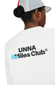 Women's long sleeve raglan T-shirt in Vanilla White with a regular fit and brushed finish. Thumb hole on sleeves. Organic Cotton and Recycled Polyester blend. Unna logo in the front and UNNA Smiles Club Print on the back.
