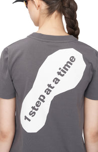 Screen print of foot print with text "1 step at a time" on grey t-shirt for women