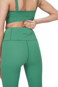 UNNA Good Place tights in pine green with a phone pocket and UNNA logo in the back.