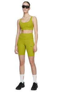 Sports bra in Golden Green with comfortable support, removable padding and adjustable strap. UNNA logo on the back. Made in Econyl.