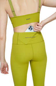 Light compression tights in Golden Green with smart pockets for your phone, airpods, and what not. UNNA logo on the front leg and "Finish in a Good Place" on the back. 