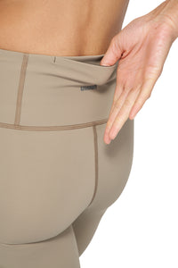 UNNA Good Place tights in stone beige with a phone pocket and UNNA logo in the back.