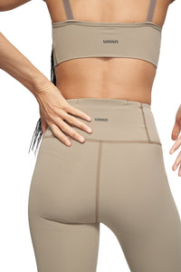 UNNA Good Place tights in stone beige with a phone pocket and UNNA logo in the back.