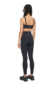 Black, high waisted, econyl tights with a phone pocket and UNNA logo in the back.
