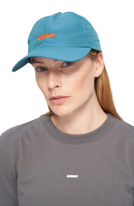 Petrol blue cap in shiny polyester with contrasting woven UNNA logo in front